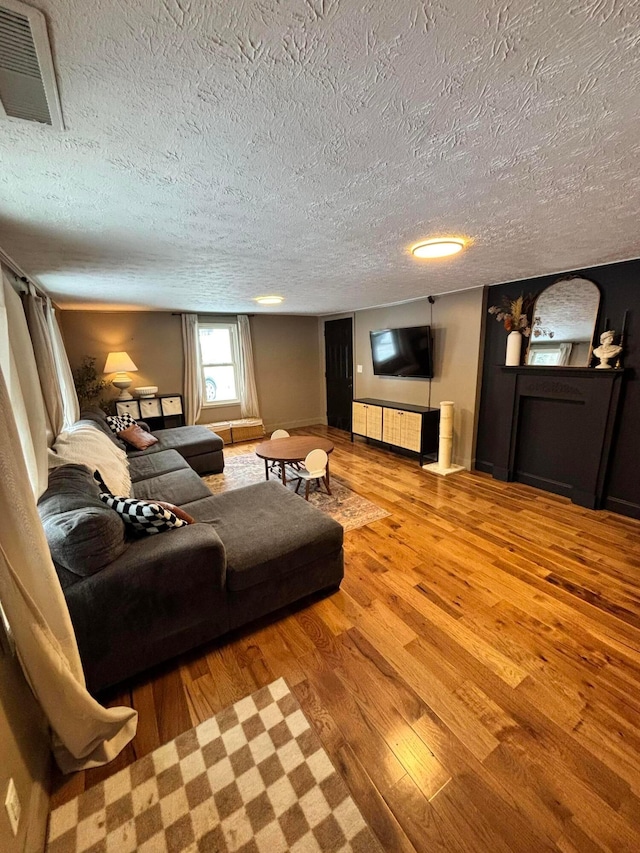 living room with hardwood / wood-style floors and a textured ceiling