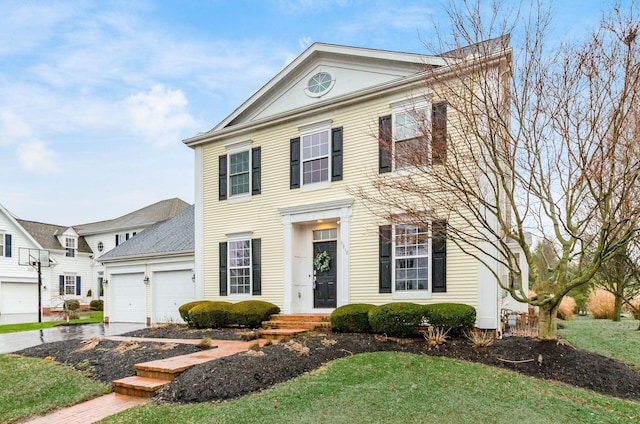 view of front of house with a garage and a front lawn