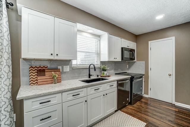 kitchen featuring white cabinetry, range with electric cooktop, tasteful backsplash, dishwasher, and sink