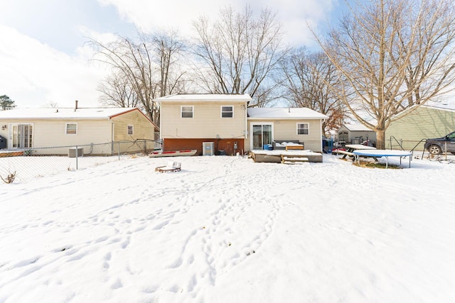 snow covered house with a trampoline