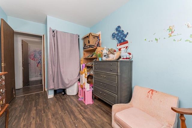 bedroom with dark wood-type flooring