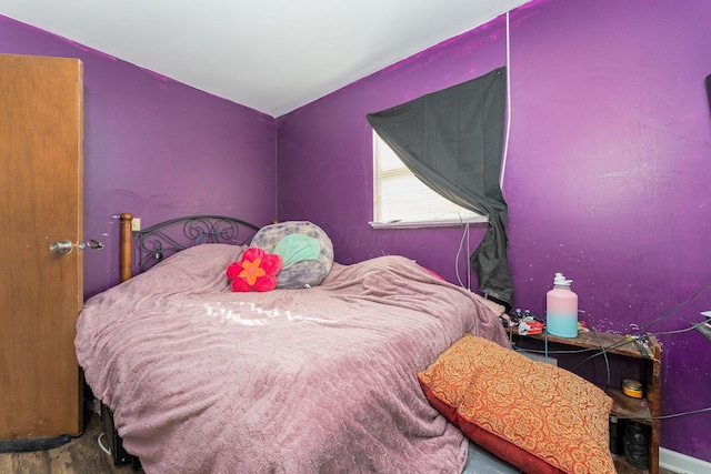 bedroom with hardwood / wood-style flooring