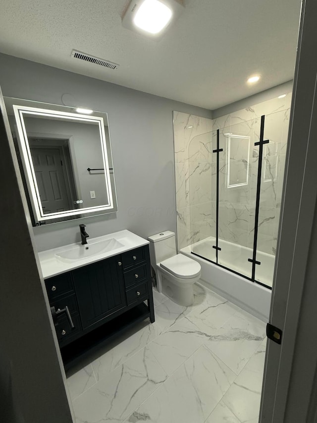 full bathroom with shower / bath combination with glass door, vanity, and toilet