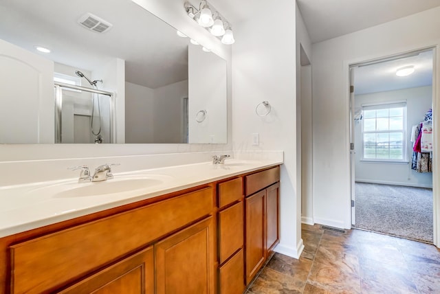 bathroom with vanity and a shower with shower door