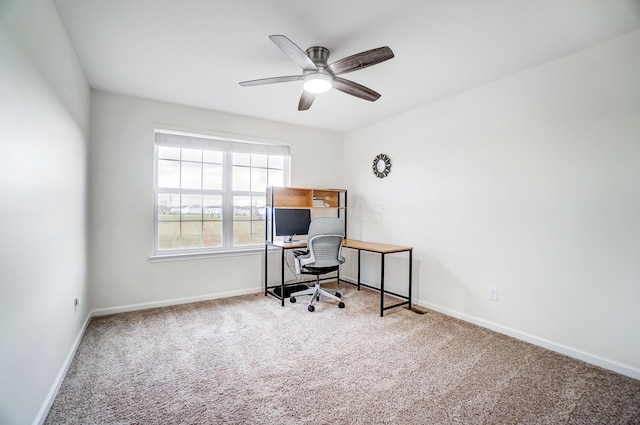 home office with ceiling fan and carpet