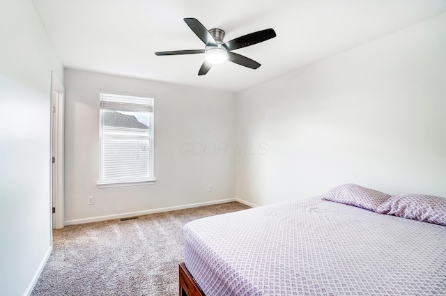 bedroom featuring ceiling fan and light carpet