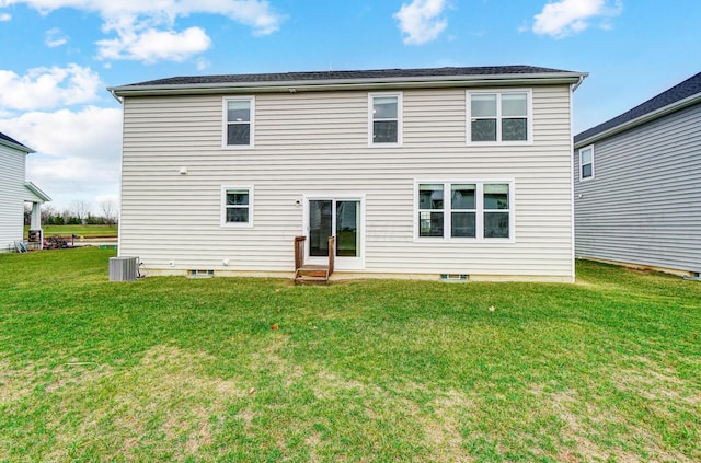 back of property featuring a lawn and cooling unit