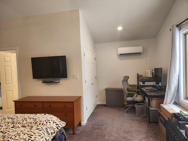 carpeted bedroom featuring a closet and a wall mounted air conditioner