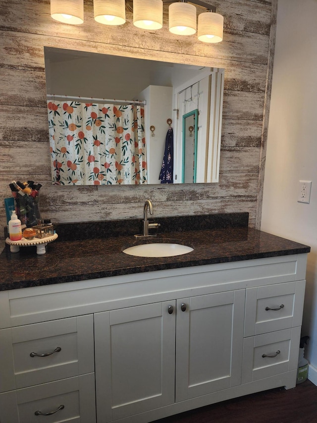 bathroom with wood walls and vanity
