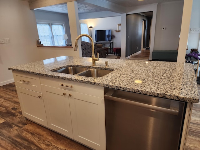 kitchen with dishwasher, light stone countertops, white cabinetry, and sink