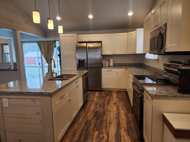 kitchen featuring appliances with stainless steel finishes, decorative light fixtures, white cabinetry, and sink