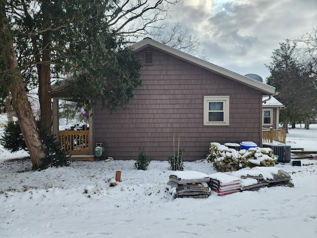 view of snowy exterior featuring cooling unit