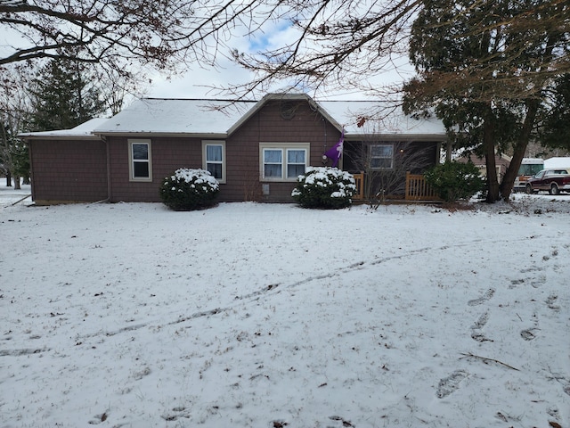 view of snow covered back of property