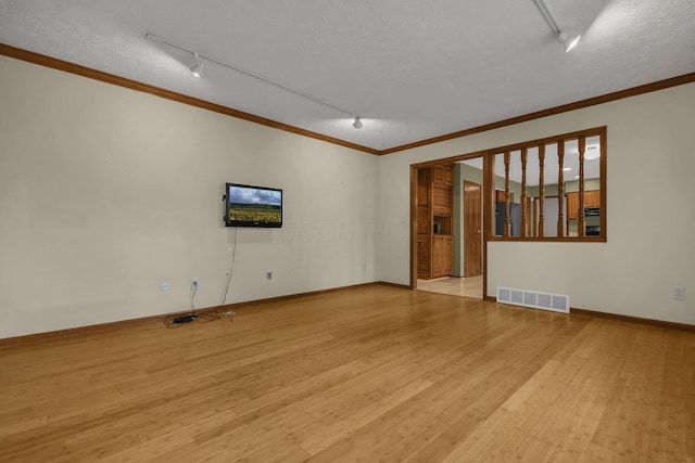 unfurnished room featuring a textured ceiling, crown molding, track lighting, and light wood-type flooring