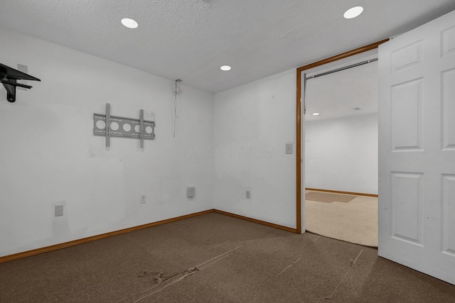 unfurnished room featuring a textured ceiling