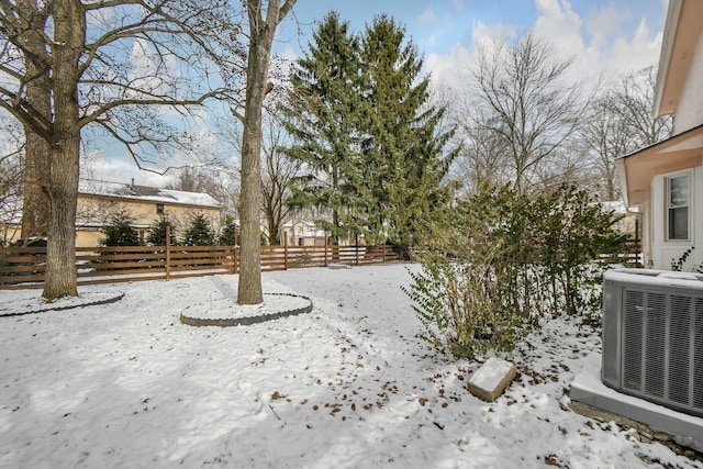 yard layered in snow with central air condition unit