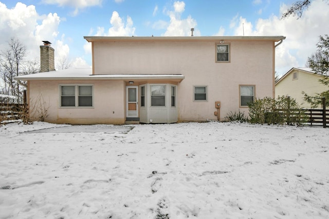 view of snow covered back of property