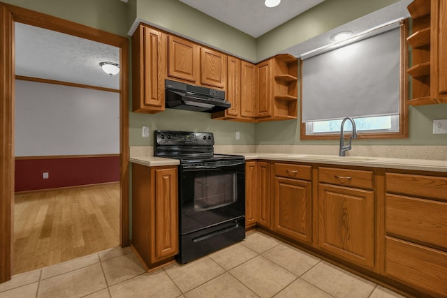 kitchen with a textured ceiling, ventilation hood, sink, light tile patterned floors, and black electric range oven