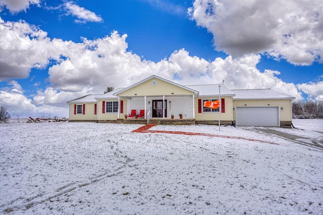 ranch-style home with a porch and a garage