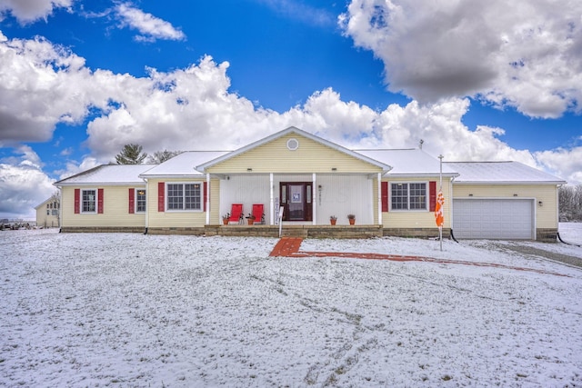 single story home featuring a porch and a garage