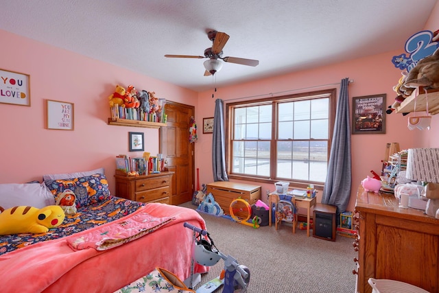 carpeted bedroom featuring a textured ceiling and ceiling fan