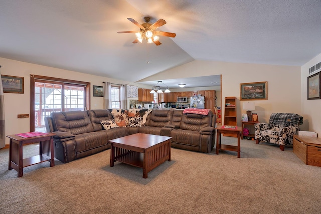 carpeted living room with ceiling fan and lofted ceiling