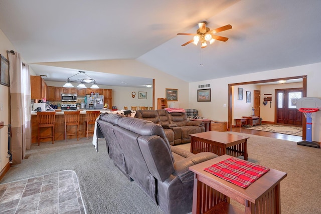 carpeted living room featuring ceiling fan and vaulted ceiling