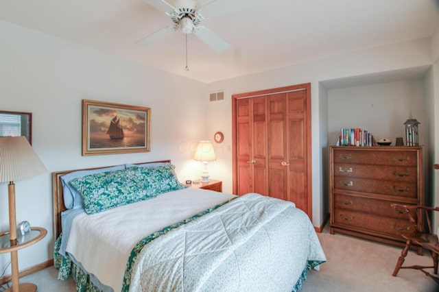 bedroom with light carpet, a closet, and ceiling fan