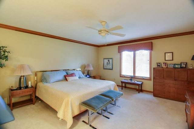 carpeted bedroom featuring ceiling fan and crown molding