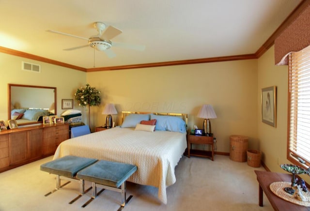 bedroom with ceiling fan, light carpet, and ornamental molding