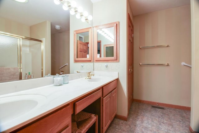 bathroom featuring vanity and an enclosed shower