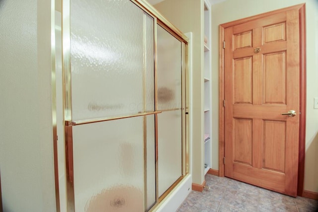 bathroom with a shower with door