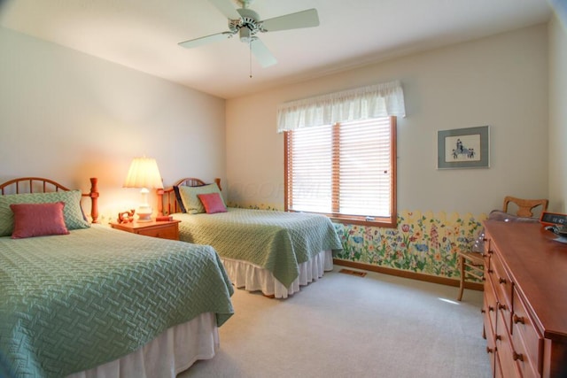 bedroom with ceiling fan and light carpet