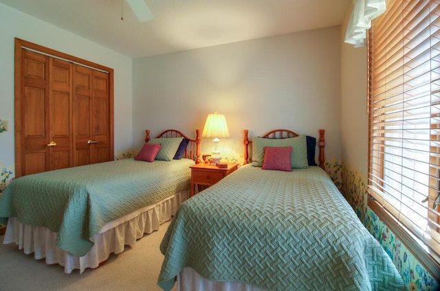 bedroom featuring carpet flooring, a closet, and ceiling fan