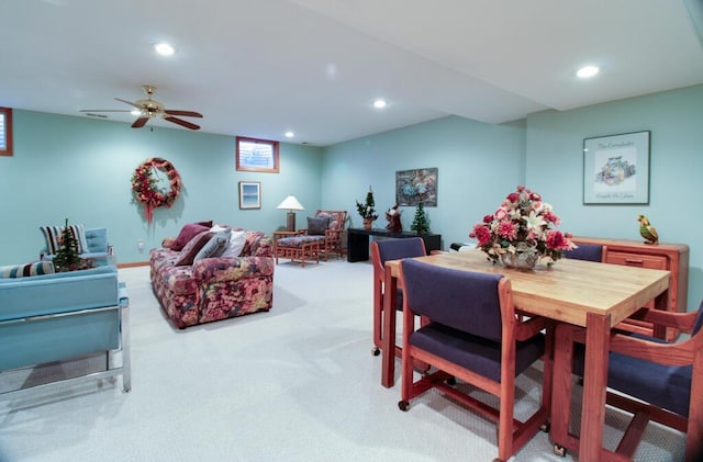 carpeted dining area featuring ceiling fan