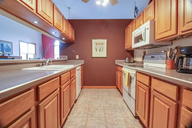 kitchen featuring white appliances, ceiling fan, and sink