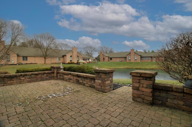 view of patio featuring a water view