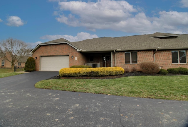 ranch-style house featuring a garage and a front lawn