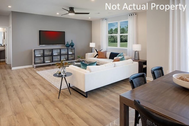 living room featuring light wood-style flooring, baseboards, ceiling fan, and recessed lighting