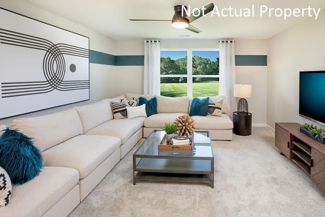 living room featuring light colored carpet, ceiling fan, and baseboards