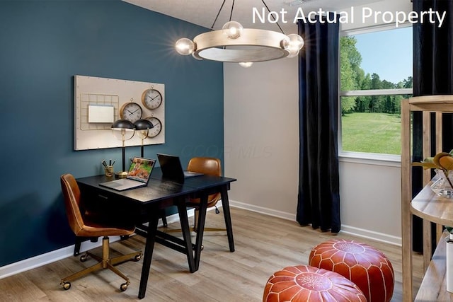dining area featuring light wood-style floors and baseboards