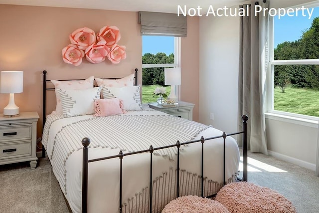 bedroom featuring light carpet and baseboards