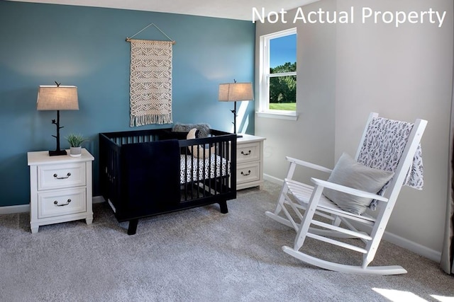 bedroom with a nursery area, light colored carpet, and baseboards
