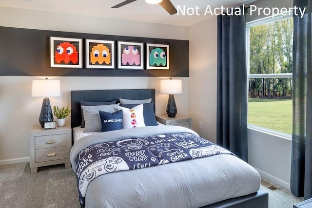 carpeted bedroom featuring ceiling fan and multiple windows