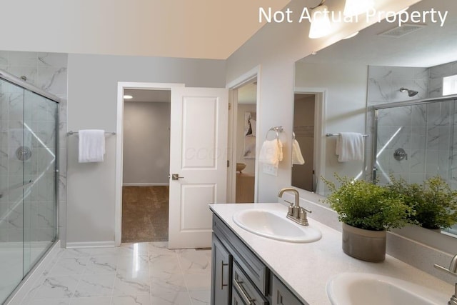 bathroom featuring vanity and an enclosed shower