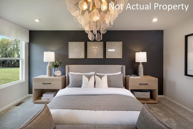 bedroom featuring a chandelier and carpet floors