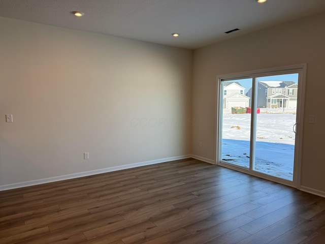 empty room featuring dark hardwood / wood-style flooring