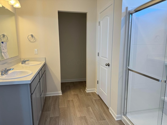 bathroom featuring vanity, hardwood / wood-style floors, and an enclosed shower