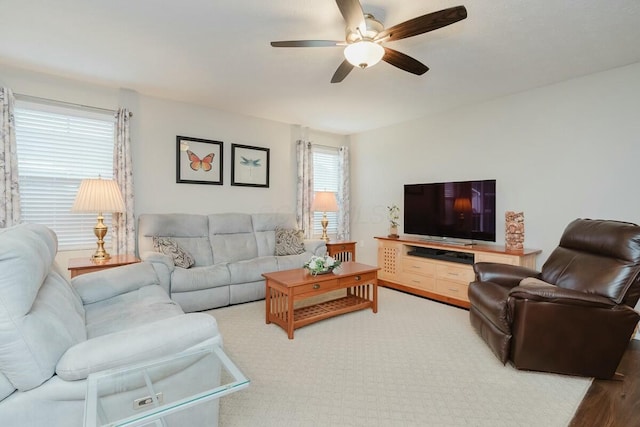 living room featuring wood-type flooring and ceiling fan