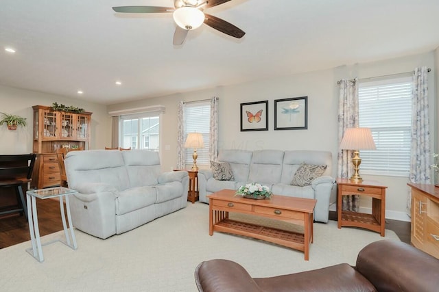 living room featuring ceiling fan and a healthy amount of sunlight